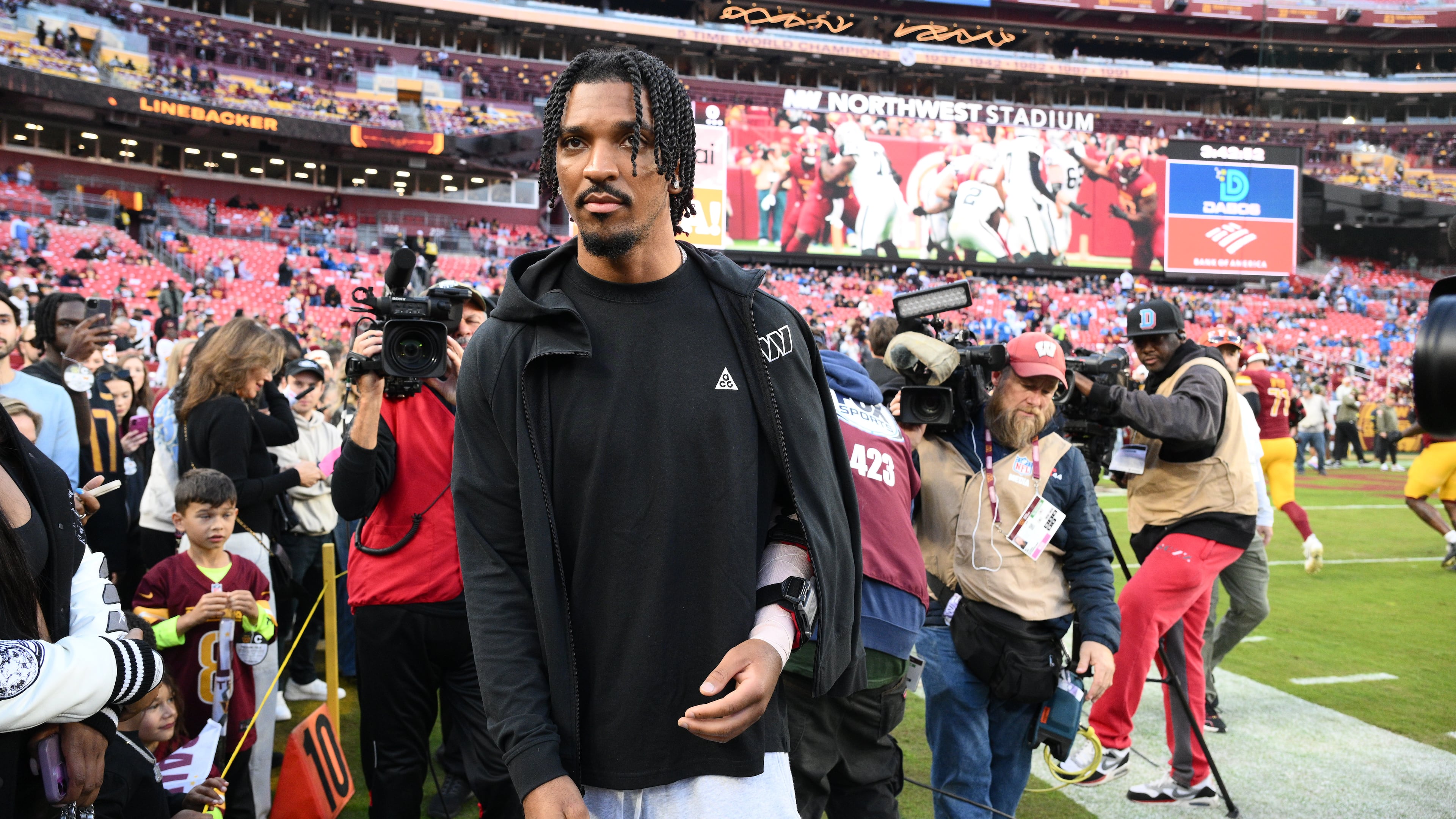 Washington Commanders quarterback Jayden Daniels (5) is seen on the sideline before an NFL football game against the Detroit Lions Sunday, Nov. 9, 2025, in Landover, Md. (AP Photo/Nick Wass)