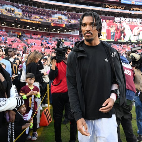 Washington Commanders quarterback Jayden Daniels (5) is seen on the sideline before an NFL football game against the Detroit Lions Sunday, Nov. 9, 2025, in Landover, Md. (AP Photo/Nick Wass)