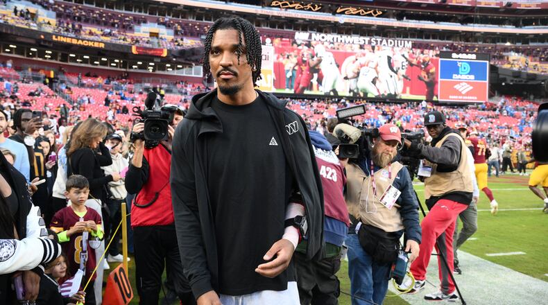 Washington Commanders quarterback Jayden Daniels (5) is seen on the sideline before an NFL football game against the Detroit Lions Sunday, Nov. 9, 2025, in Landover, Md. (AP Photo/Nick Wass)