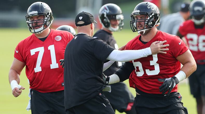 July 27, 2017 Flowery Branch: Falcons head coach Dan Quinn works with offensive guards Wes Schweitzer and Ben Garland (right) on the first day of team practice at training camp on Thursday, July 27, 2017, in Flowery Branch. Curtis Compton/ccompton@ajc.com