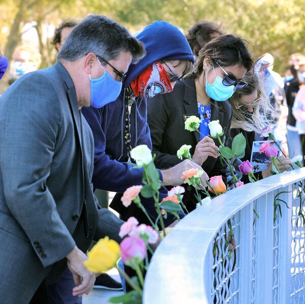 Guests place flowers during the Day of Remembrance ceremony honoring astronauts killed in the 1986 Challenger shuttle disaster at the Space Mirror Memorial during a 35th anniversary commemoration at Kennedy Space Center on Thursday. (Joe Burbank/Orlando Sentinel/TNS)