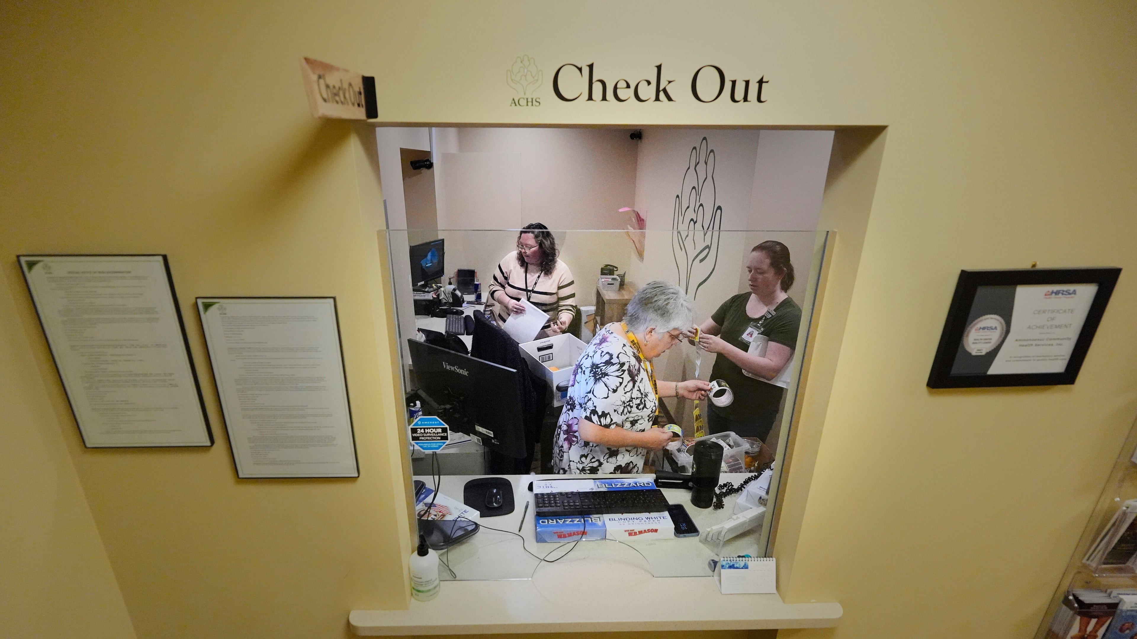 Employees at Ammonoosuc Community Health Services pack up the reception office as the clinic closes for good, Thursday, Oct. 23, 2025, in Franconia, N.H. (AP Photo/Robert F. Bukaty)