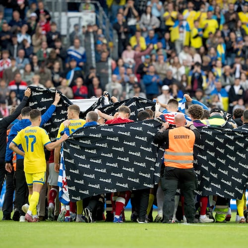 Denmark's and Ukraine's players accompany Christian Eriksen to a waiting ambulance during the international friendly soccer match between Denmark and Ukraine in Odense, Denmark, Sunday, June 7, 2026, after Eriksen has collapsed on the field again while playing for Denmark’s national team. (Bo Amstrup/Ritzau Scanpix via AP)