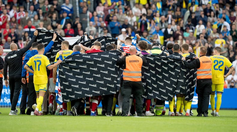 Denmark's and Ukraine's players accompany Christian Eriksen to a waiting ambulance during the international friendly soccer match between Denmark and Ukraine in Odense, Denmark, Sunday, June 7, 2026, after Eriksen has collapsed on the field again while playing for Denmark’s national team. (Bo Amstrup/Ritzau Scanpix via AP)
