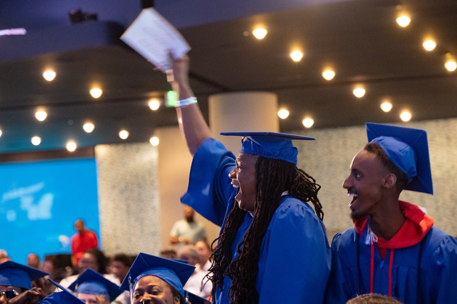 Graduates of Goodwill of North Georgia job training program and career development programs cheer during a graduation ceremony at the Georgia Aquarium in Atlanta on Monday, June 9, 2025.   Ben Gray for the Atlanta Journal-Constitution