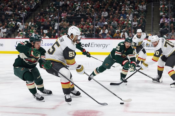 Vegas Golden Knights right wing Keegan Kolesar (55) handles the puck against Minnesota Wild center Marco Rossi (23) during the second period in Game 4 of an NHL hockey Stanley Cup first-round playoff series, Saturday, April 26, 2025, in St. Paul, Minn. (AP Photo/Stacy Bengs)