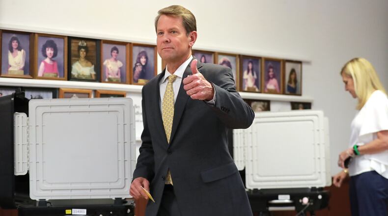 Secretary of State Brian Kemp signals confidence after casting his ballot Tuesday at the Winterville Train Depot in the Republican runoff for governor. Kemp, who won by a comfortable margin, will face Democrat Stacey Abrams in November’s general election. Curtis Compton/ccompton@ajc.com