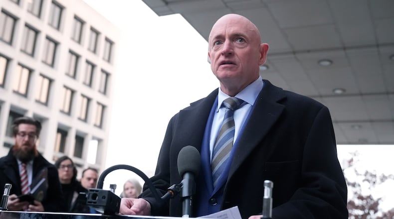 Sen. Mark Kelly, D-Ariz.,speaks to reporters outside of federal court in Washington, Tuesday, Feb. 3, 2026. (AP Photo/Mark Schiefelbein)