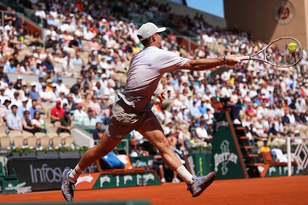Tommy Paul of the U.S. returns the ball to Australia's Alexei Popyrin during their fourth round match of the French Tennis Open, at the Roland-Garros stadium, in Paris, Sunday, June 1 2025. (AP Photo/Lindsey Wasson)