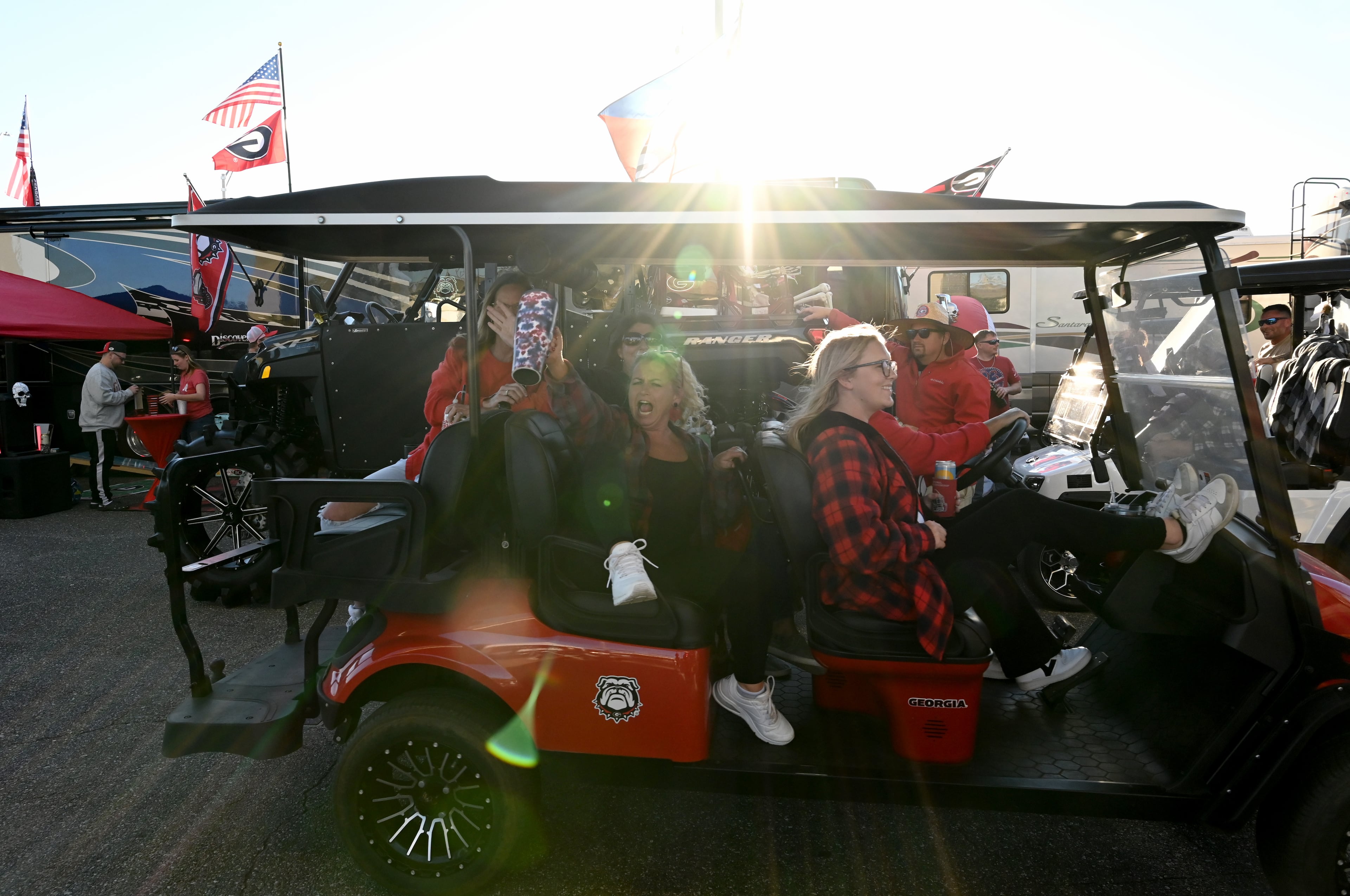 Georgia fans ride a decorated golf cart during tailgating ahead of the NCAA football game Saturday between Georgia and Florida in RV City outside EverBank Stadium, Friday, October 31, 2025, Jacksonville, Fla. (Hyosub Shin / AJC)