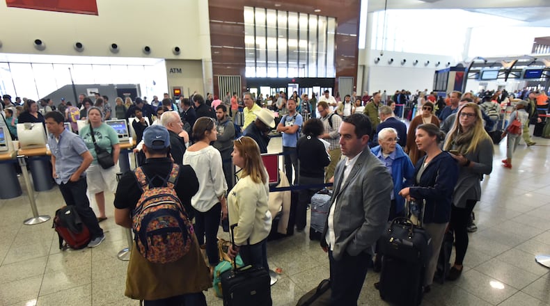 Delta passengers wait in line in hopes of catching their flight out of Hartsfield-Jackson Atlanta International Airport on Friday, April 7, 2017. HYOSUB SHIN / HSHIN@AJC.COM