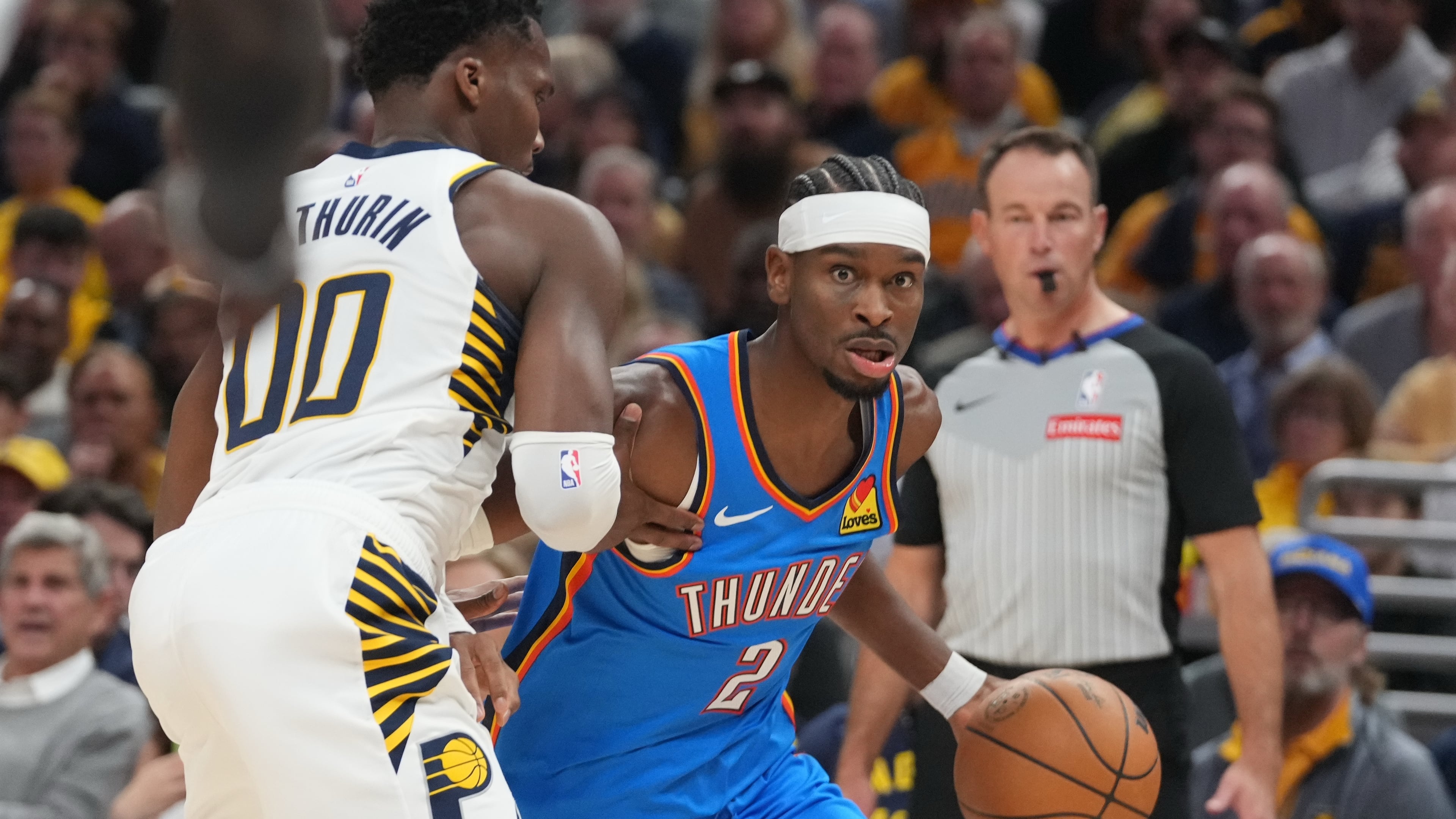 Oklahoma City Thunder's Shai Gilgeous-Alexander (2) is defended by Indiana Pacers' Bennedict Mathurin (00) during the first half of an NBA basketball game, Thursday, Oct. 23, 2025, in Indianapolis. (AP Photo/Darron Cummings)