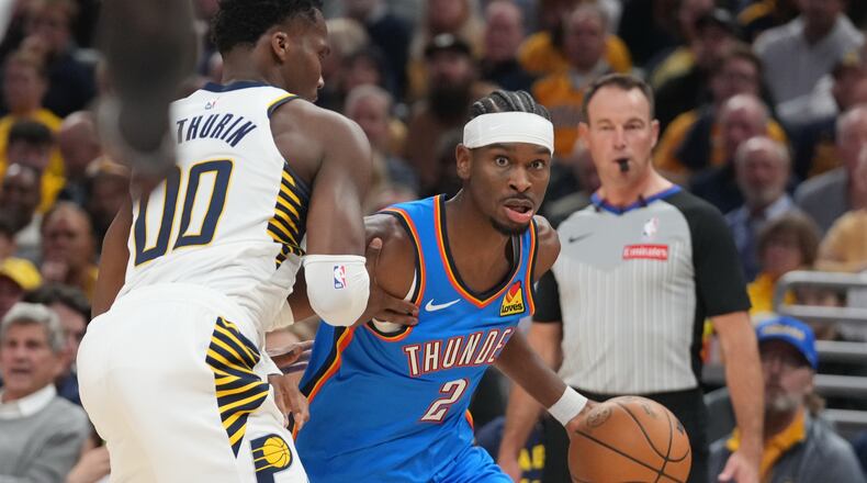 Oklahoma City Thunder's Shai Gilgeous-Alexander (2) is defended by Indiana Pacers' Bennedict Mathurin (00) during the first half of an NBA basketball game, Thursday, Oct. 23, 2025, in Indianapolis. (AP Photo/Darron Cummings)