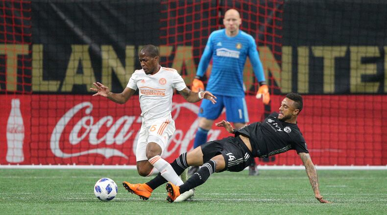 Atlanta United midfielder Darlington Nagbe battles Sporting Kansas City forward Khiry Shelton during the first half Wednesday, May 9, 2018, in Atlanta.