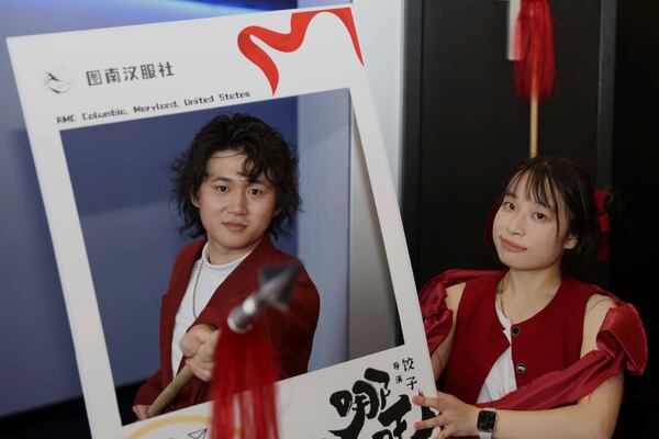 This photo provided by Jialin Sun shows Sun Bohan, the organizer of the movie screening and Hoff Xu, who cosplayed the character in the movie Ne Zha 2, posing for a picture at a screening in Columbia Md., on March 1.(Jialin Sun via AP)