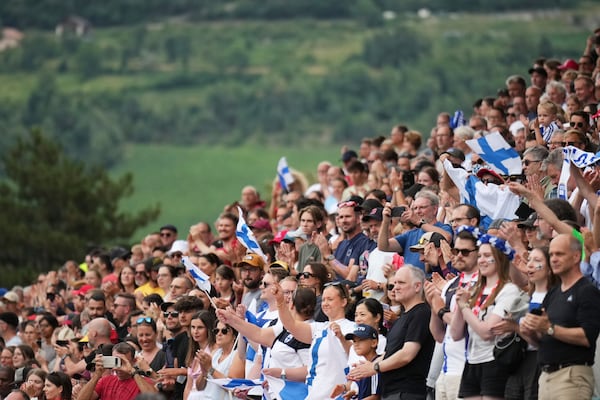Finland fans stand during the national anthem before the Euro 2025, group A, soccer match between Norway and Finland at Stade de Tourbillon in Sion, Switzerland, Sunday, July 6, 2025. (AP Photo/Alessandra Tarantino)