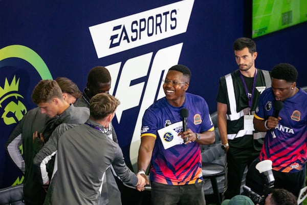Esports competitors congratulate each other during EA Sports FC competition at the ePremier Fan Festival on Saturday, Aug. 2, 2025, at Mercedes-Benz Stadium. (Ben Hendren for the AJC)