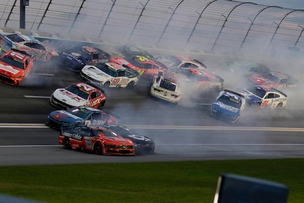 Twenty plus cars tangle up in turn three of lap sixty nine during a NASCAR Cup Series auto race, Saturday, June 28, 2025, in Hampton, Ga. (AP Photo/Russell Norris)