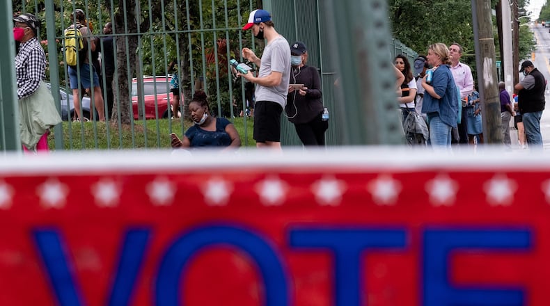 Voters wait in line at the Fanplex voting site late Tuesday evening June 9, 2020 across from the old Turner Field in Atlanta. Voters were reporting a three-hour wait at the site. Ben Gray for the Atlanta Journal-Constitution