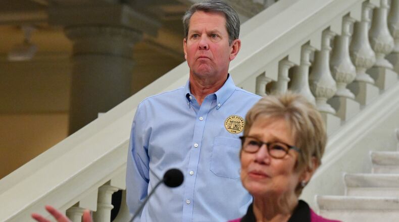 Dr. Kathleen Toomey, commissioner of Georgia Department of Public Health, speaks as Governor Brian Kemp looks during a press briefing to update on COVID-19 at the Georgia State Capitol on May 12, 2020. (Hyosub Shin / Hyosub.Shin@ajc.com)