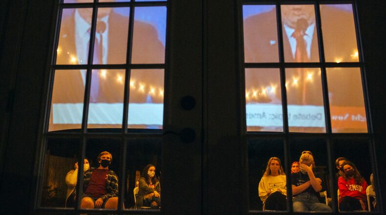 The third and final debate between President Donald Trump and Joe Biden, his Democratic challenger, is projected onto a screen during an outdoor watch party at a home in New Jersey on Oct. 22. (Michelle Gustafson/The New York Times)