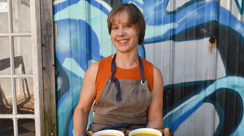 Stella Dillard, owner of Dandelion Food and Goods, shows three of her broths: (back row from left) Sweet Potato Wonderbroth and Beef Curry Broth and (front) Vegan Ramen Broth. (Styling by Stella Dillard / Chris Hunt for the AJC)