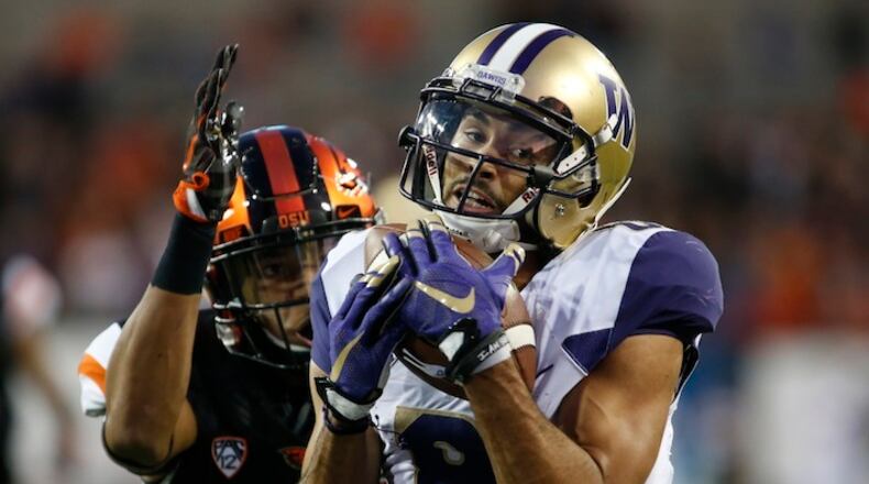 Washington wide receiver Dante Pettis (8) makes a touchdown catch after getting behind Oregon State's Isaiah Dunn (22) in the second half of an NCAA college football game, in Corvallis, Ore., Saturday, Sept. 30, 2017. Washington won 42-7. (AP Photo/Timothy J. Gonzalez)
