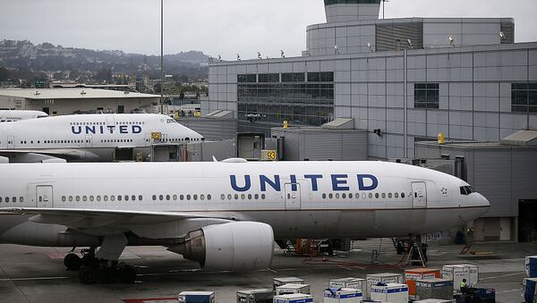 United Airlines planes sit on an airport tarmac