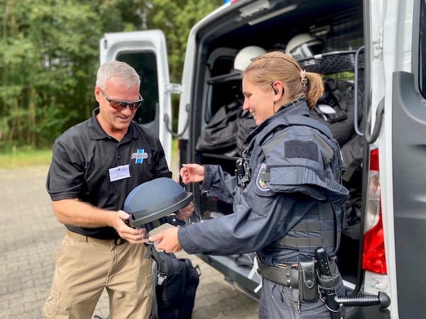Sandy Springs Chief of Police Kenneth DeSimone tries on German ballistic helmet (Courtesy of Katja Ridderbusch)