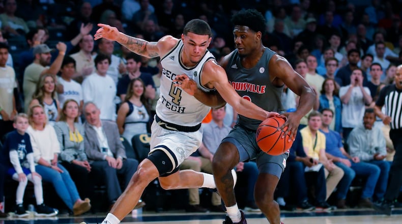 Georgia Tech guard Jordan Usher (4) takes the ball away from Louisville forward Jae'Lyn Withers (3) during the first half of an NCAA college basketball game in Atlanta, Wednesday, Feb. 12, 2020. (AP Photo/Todd Kirkland)