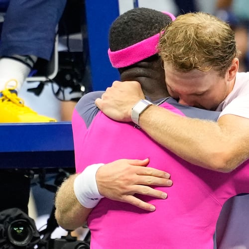 Frances Tiafoe, left, of the United States, and Alex Michelsen, of the United States, embrace after Tiafoe won their match in the quarterfinal round of the U.S. Open tennis championships, Tuesday, Sept. 8, 2026, in New York. (AP Photo/Yuki Iwamura) CORRECTION: Corrects Tiafoe to left, not right.