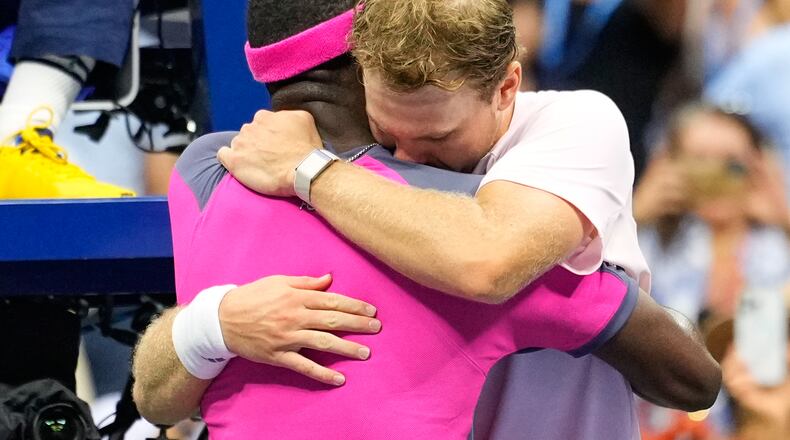 Frances Tiafoe, left, of the United States, and Alex Michelsen, of the United States, embrace after Tiafoe won their match in the quarterfinal round of the U.S. Open tennis championships, Tuesday, Sept. 8, 2026, in New York. (AP Photo/Yuki Iwamura) CORRECTION: Corrects Tiafoe to left, not right.