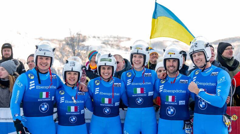 The Italian relay team with Verena Hofer, Ivan Nagler, Fabian Malleier, Dominik Fischnaller, Andrea Voetter and Marion Oberhofer celebrate their third place at the mixed relay competition of the Luge World Cup in Winterberg, Germany, Sunday Jan. 11, 2026. (David Inderlied/dpa via AP)