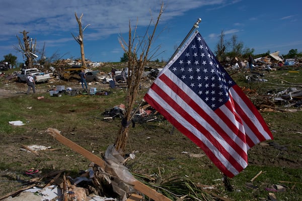 An American Flag is posted near destroyed homes, Sunday, May 18, 2025, in London, Ky., after a severe storm passed through the area. (AP Photo/Carolyn Kaster)