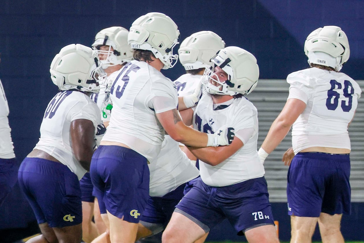 Georgia Tech offensive lineman Ethan Mackenny (second from right), participates in a drill with lineman Andrew Rosinski (second from left) during the first day of football practice at Rose Bowl Field and the Mary and John Brock Football Practice Facility, at Georgia Tech in Atlanta, Monday, Aug. 3, 2026. (Miguel Martinez/AJC)