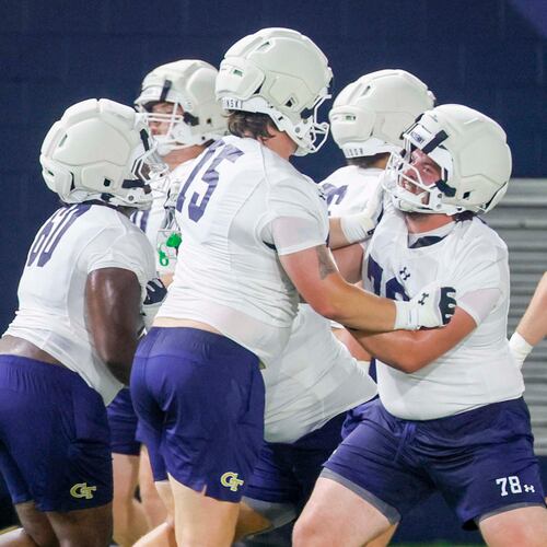 Georgia Tech offensive lineman Ethan Mackenny (second from right), participates in a drill with lineman Andrew Rosinski (second from left) during the first day of football practice at Rose Bowl Field and the Mary and John Brock Football Practice Facility, at Georgia Tech in Atlanta, Monday, Aug. 3, 2026. (Miguel Martinez/AJC)