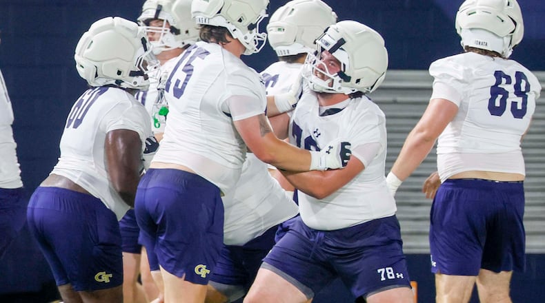 Georgia Tech offensive lineman Ethan Mackenny (second from right), participates in a drill with lineman Andrew Rosinski (second from left) during the first day of football practice at Rose Bowl Field and the Mary and John Brock Football Practice Facility, at Georgia Tech in Atlanta, Monday, Aug. 3, 2026. (Miguel Martinez/AJC)