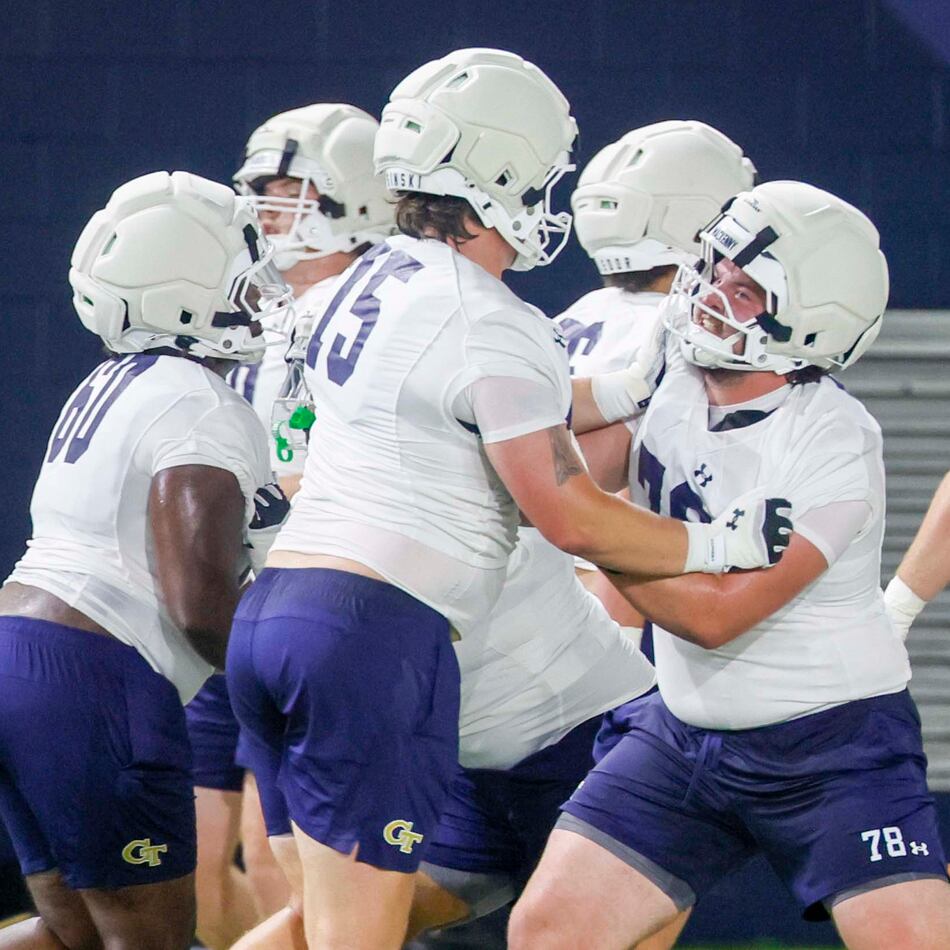Georgia Tech offensive lineman Ethan Mackenny (second from right), participates in a drill with lineman Andrew Rosinski (second from left) during the first day of football practice at Rose Bowl Field and the Mary and John Brock Football Practice Facility, at Georgia Tech in Atlanta, Monday, Aug. 3, 2026. (Miguel Martinez/AJC)