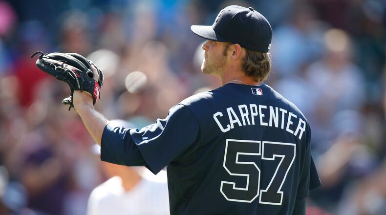 Atlanta Braves relief pitcher David Carpenter calls for a new ball after giving up a three-run home run to Colorado Rockies' Troy Tulowitzki in the bottom of the sixth inning of a baseball game, Sunday, July 12, 2015, in Denver. (AP Photo/David Zalubowski)