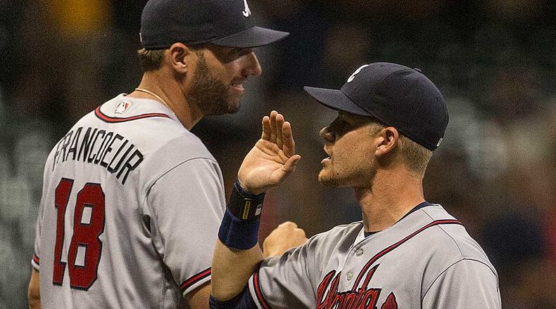 Gordon Beckham, who delivered the key sacrifice fly in the 12th, celebrates with Jeff Francoeur after the Braves' 4-3 win Monday.