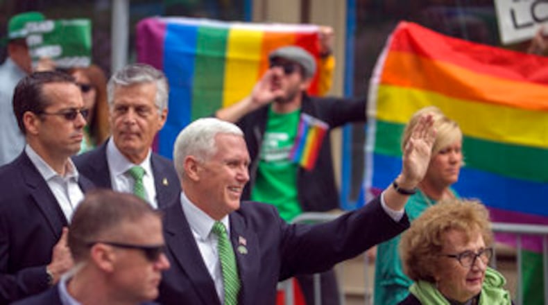 Vice President Mike Pence and his mother, Nancy Pence Fritsch, right, wave Saturday while walking in the St. Patrick’s Day Parade in Savannah. (AP Photo/Stephen B. Morton)