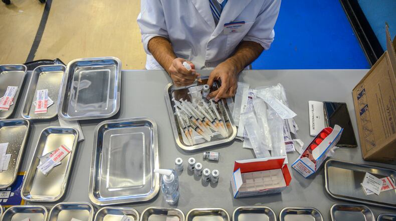 In this file photo, a pharmicist prepares COVID-19 vaccines in New York. (Brittainy Newman/The New York Times)
