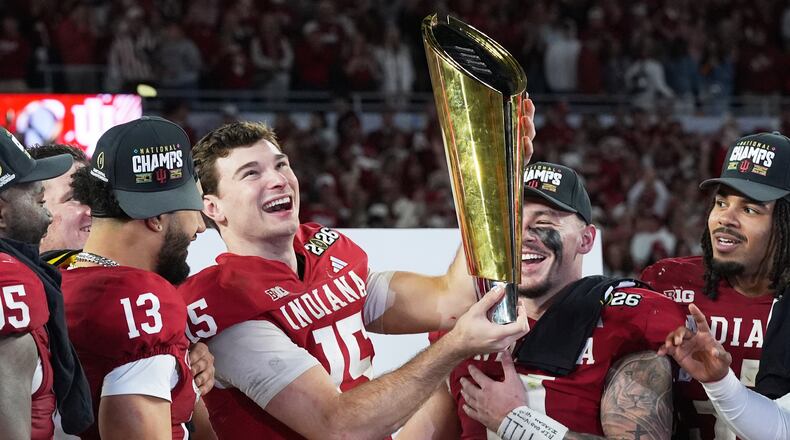 Indiana quarterback Fernando Mendoza holds the trophy after their win against Miami in the College Football Playoff national championship game, Monday, Jan. 19, 2026, in Miami Gardens, Fla. (AP Photo/Marta Lavandier)