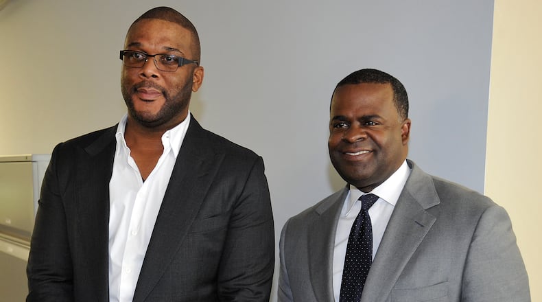 Atlanta Mayor Kasim Reed and filmmaker Tyler Perry at the meeting announcing Perry's purchase of 330 acres at the former Fort McPherson Army base on Aug. 8, 2014. AJC file photo: David Tulis