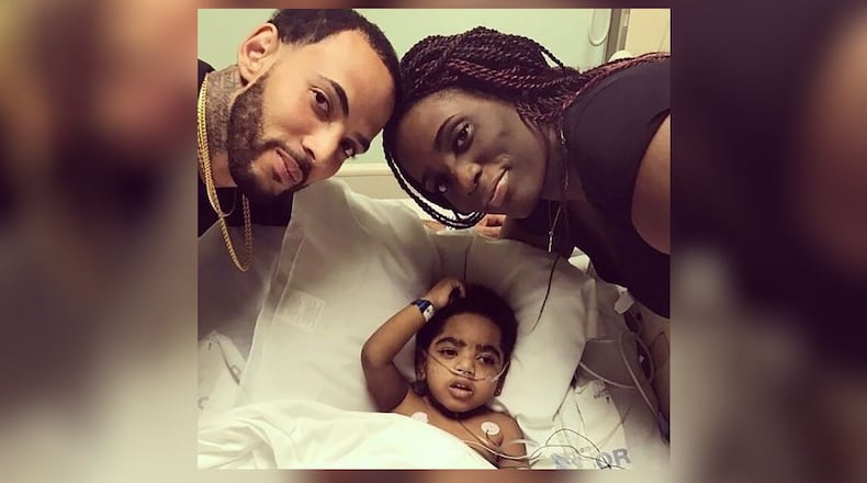 Two-year-old A.J. Burgess with his parents, Carmellia Burgess and Anthony Dickerson.
