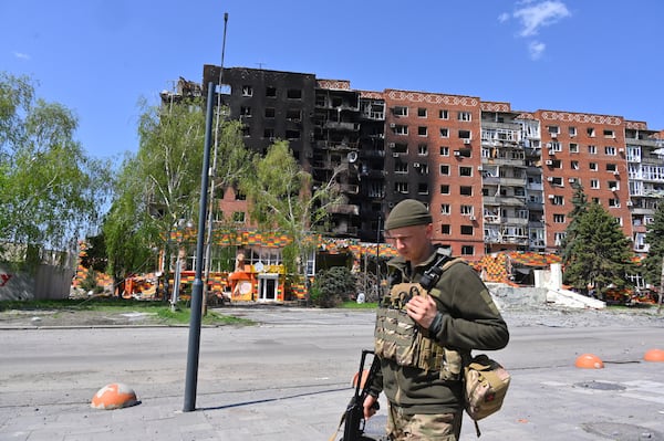 FILE - A Ukrainian soldier walks past damaged buildings in central Pokrovsk, the site of the heaviest battles with the Russian troops in the Donetsk region of Ukraine, April 23, 2025. (AP Photo/Michael Shtekel, File)