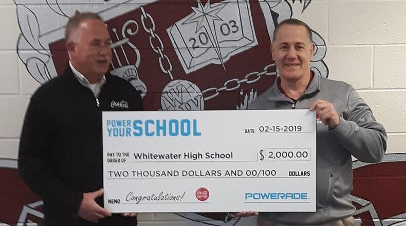 Chris Milewski (left), market development manager for Coca-Cola, presented Whitewater’s athletic director, Mike Vena, with a $2,000 grant for the school’s sports programs. Courtesy Fayette County Board of Education