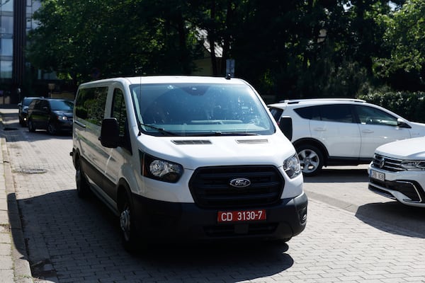 A car carrying released Belarusian dissidents arrives at the US Embassy in Vilnius, Lithuania, Saturday, June 21, 2025 (AP Photo/Mindaugas Kulbis)