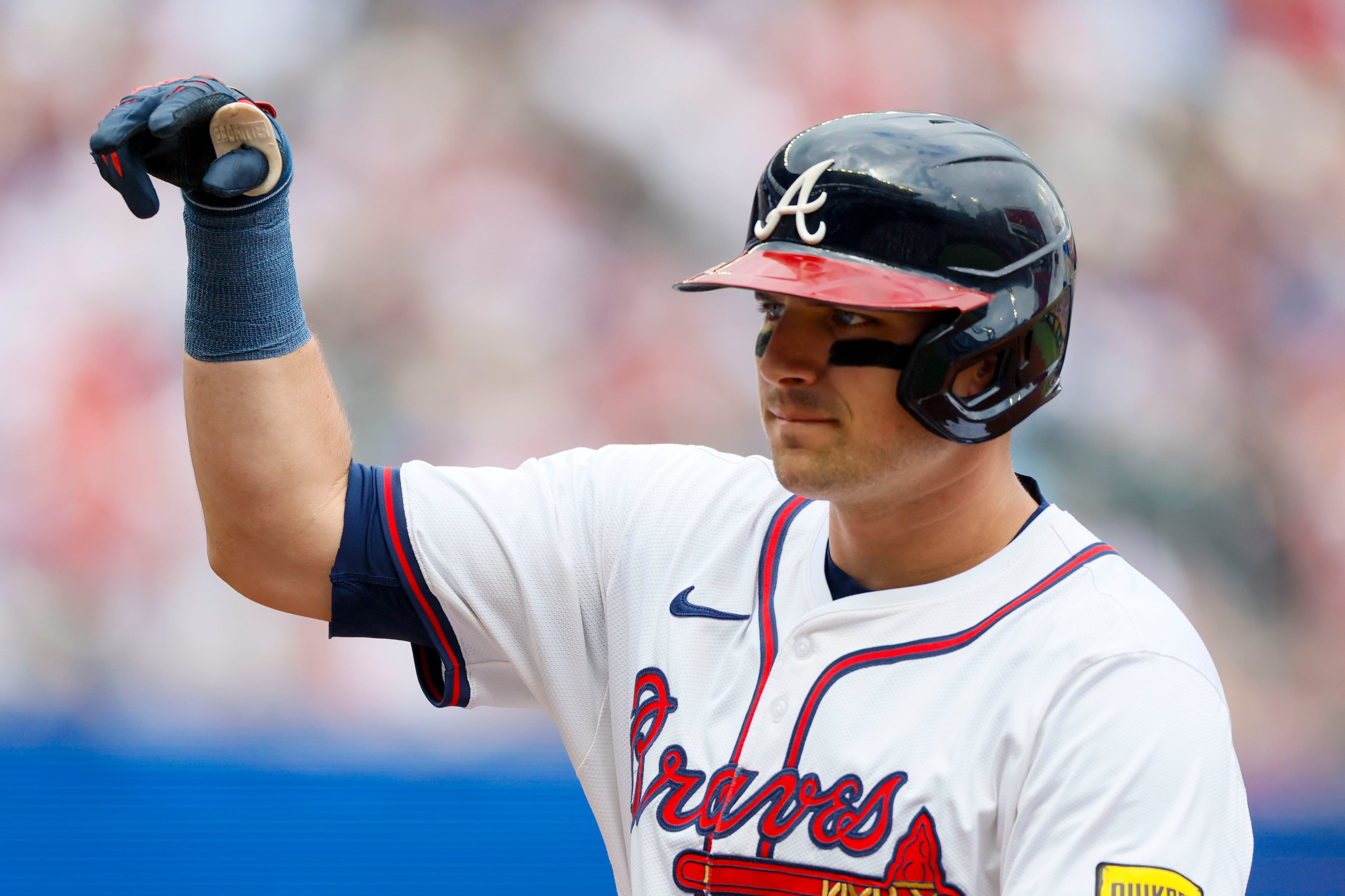 Atlanta Braves third baseman Austin Riley (27) signals teammates after a single during the second inning of a baseball game against the San Diego Padres on Sunday, May 25, 2025, in Atlanta (Miguel Martinez/Atlanta Journal-Constitution via AP)