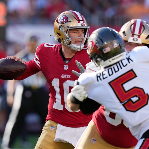 San Francisco 49ers quarterback Mac Jones, left, passes as Tampa Bay Buccaneers outside linebacker Haason Reddick applies pressure during the first half of an NFL football game in Tampa, Fla., Sunday, Oct. 12, 2025. (Chris O'Meara/AP)